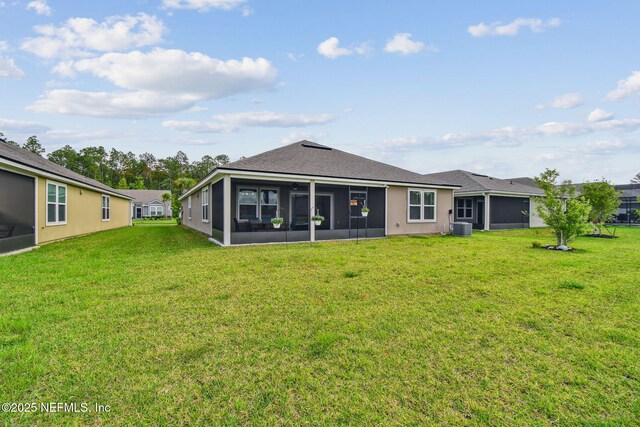 100 Dove Tree Ln, Saint Augustine, FL 32095 - back of house featuring a sunroom, a lawn, and a shingled roof