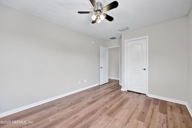 168 Pinehurst Pointe Dr, Saint Augustine, FL 32092 - unfurnished bedroom with light wood finished floors, a textured ceiling, and a ceiling fan