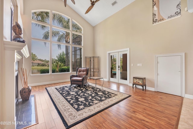 168 Pinehurst Pointe Dr, Saint Augustine, FL 32092 - living area featuring french doors, high vaulted ceiling, plenty of natural light, and wood finished floors
