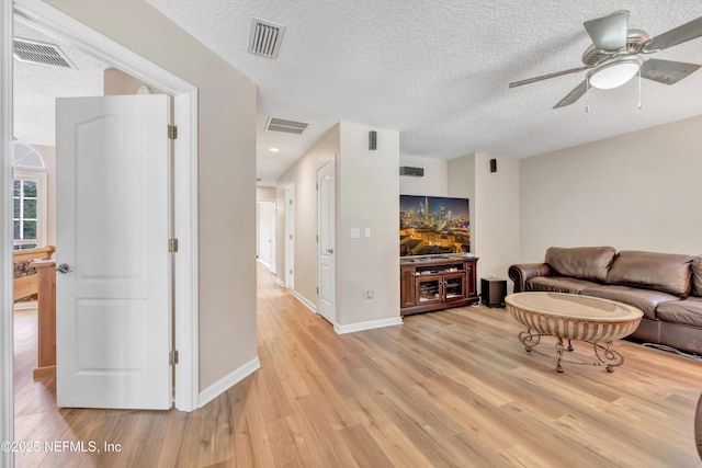 168 Pinehurst Pointe Dr, Saint Augustine, FL 32092 - living area with light wood finished floors, ceiling fan, and a textured ceiling