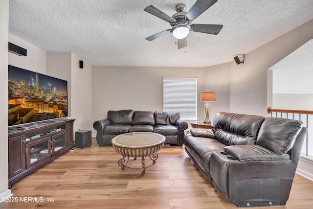 168 Pinehurst Pointe Dr, Saint Augustine, FL 32092 - living room featuring a textured ceiling, a ceiling fan, and light wood finished floors