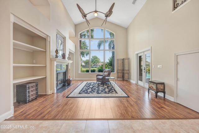 168 Pinehurst Pointe Dr, Saint Augustine, FL 32092 - foyer entrance with high vaulted ceiling, a fireplace, french doors, wood finished floors, and a ceiling fan
