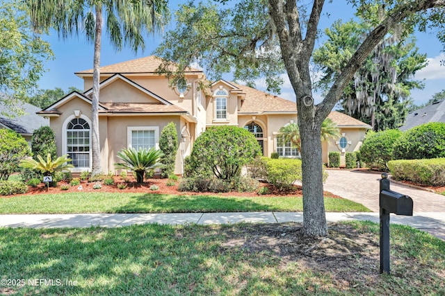 168 Pinehurst Pointe Dr, Saint Augustine, FL 32092 - view of front of house featuring stucco siding, a front yard, and decorative driveway