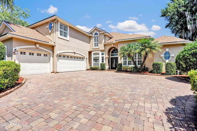 168 Pinehurst Pointe Dr, Saint Augustine, FL 32092 - mediterranean / spanish-style home with decorative driveway, stucco siding, and an attached garage