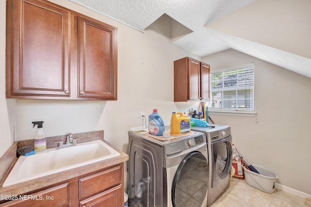 168 Pinehurst Pointe Dr, Saint Augustine, FL 32092 - washroom with washer and dryer, cabinet space, a textured ceiling, and light tile patterned floors