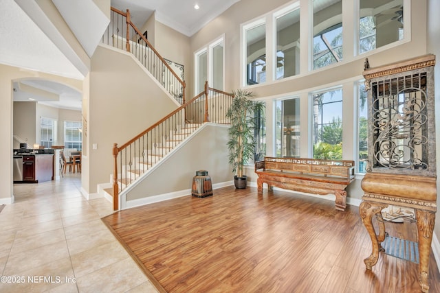168 Pinehurst Pointe Dr, Saint Augustine, FL 32092 - foyer featuring a high ceiling, stairway, arched walkways, light wood-style floors, and recessed lighting