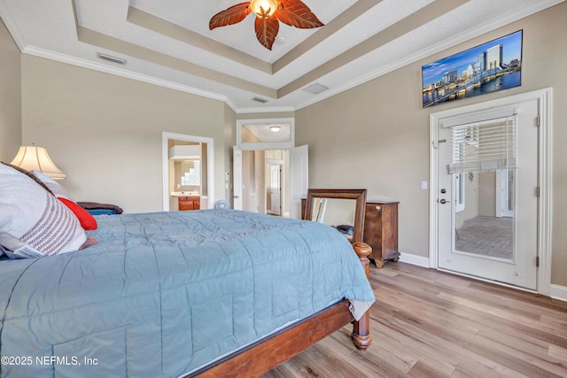 168 Pinehurst Pointe Dr, Saint Augustine, FL 32092 - bedroom featuring wood finished floors, a raised ceiling, access to exterior, ornamental molding, and connected bathroom