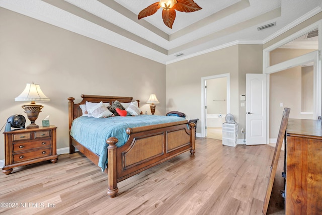 168 Pinehurst Pointe Dr, Saint Augustine, FL 32092 - bedroom featuring light wood-style flooring, a raised ceiling, ornamental molding, and connected bathroom