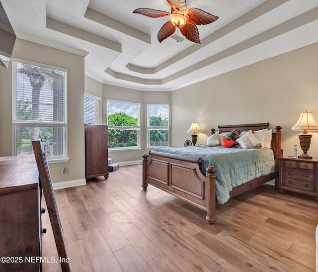 168 Pinehurst Pointe Dr, Saint Augustine, FL 32092 - bedroom featuring a tray ceiling, light wood-style floors, and crown molding