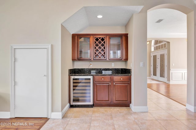 168 Pinehurst Pointe Dr, Saint Augustine, FL 32092 - indoor bar with beverage cooler, arched walkways, light tile patterned floors, recessed lighting, and a textured ceiling