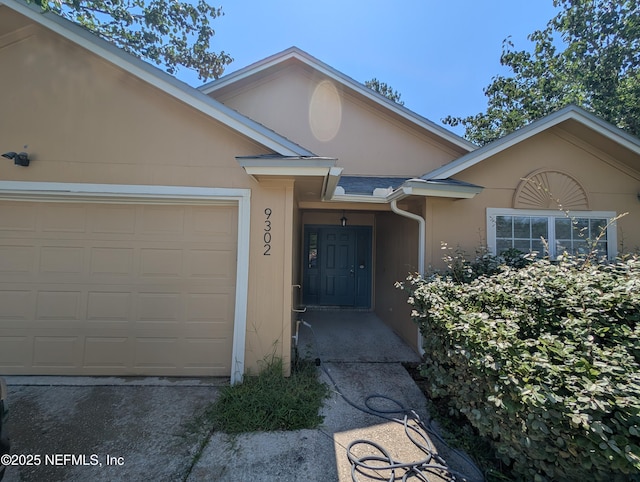 9302 Cumberland Station Dr, Jacksonville, FL 32257 - entrance to property with stucco siding and an attached garage