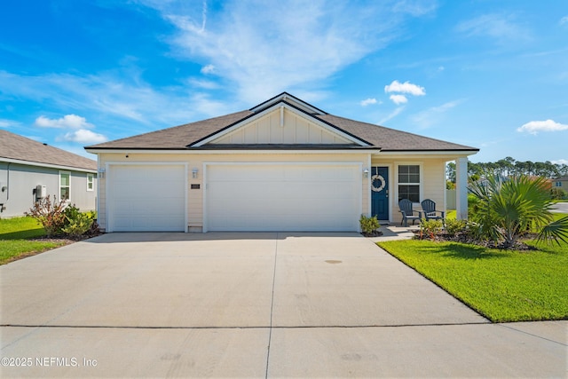 197 Jarama Cir, Saint Augustine, FL 32084 - view of front of home with concrete driveway, an attached garage, board and batten siding, and a front yard