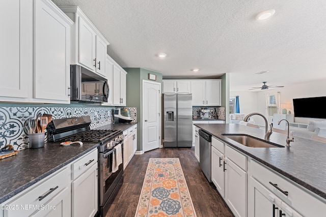 197 Jarama Cir, Saint Augustine, FL 32084 - kitchen featuring appliances with stainless steel finishes, ceiling fan, white cabinetry, a textured ceiling, and dark wood finished floors