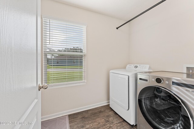 197 Jarama Cir, Saint Augustine, FL 32084 - laundry room featuring washer and clothes dryer, healthy amount of natural light, and dark wood-style flooring