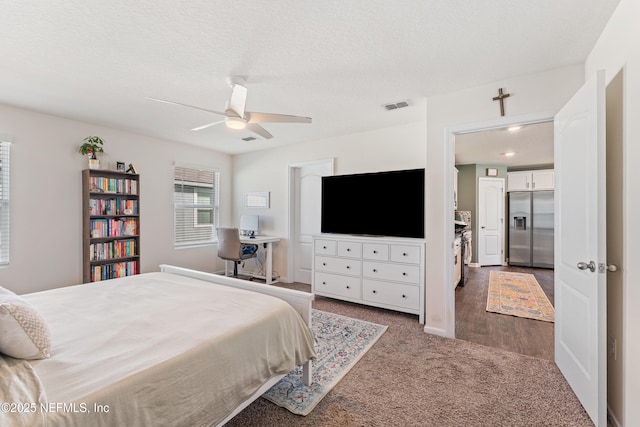 197 Jarama Cir, Saint Augustine, FL 32084 - carpeted bedroom with stainless steel fridge with ice dispenser, ceiling fan, and a textured ceiling