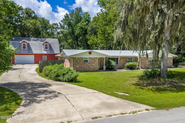 136 Hollywood Forest Dr, Fleming Island, FL 32003 - single story home with concrete driveway, brick siding, and a front lawn