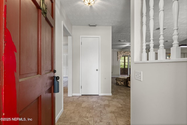 136 Hollywood Forest Dr, Fleming Island, FL 32003 - hall featuring a textured ceiling and light stone finish floors