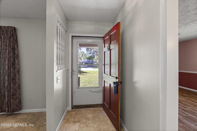 136 Hollywood Forest Dr, Fleming Island, FL 32003 - entryway with a textured ceiling and baseboards
