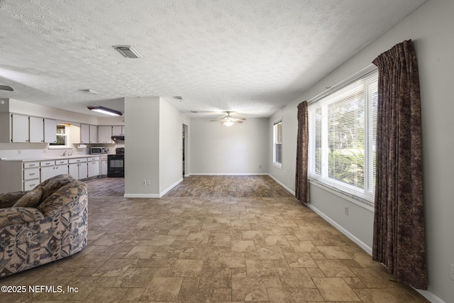 136 Hollywood Forest Dr, Fleming Island, FL 32003 - living area with a ceiling fan, stone finish flooring, and a textured ceiling