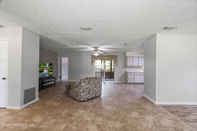 136 Hollywood Forest Dr, Fleming Island, FL 32003 - living area with a ceiling fan, a textured ceiling, and stone finish flooring