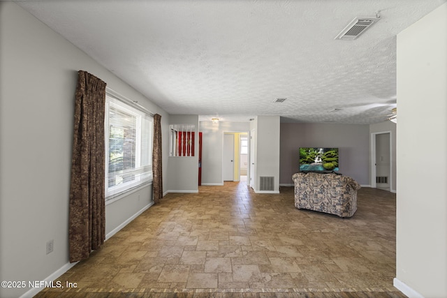 136 Hollywood Forest Dr, Fleming Island, FL 32003 - unfurnished living room with stone finish flooring and a textured ceiling