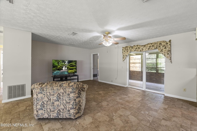 136 Hollywood Forest Dr, Fleming Island, FL 32003 - living area with stone tile flooring, ceiling fan, and a textured ceiling