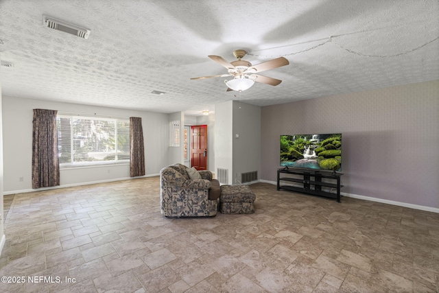 136 Hollywood Forest Dr, Fleming Island, FL 32003 - living room featuring stone finish floors, a ceiling fan, and a textured ceiling