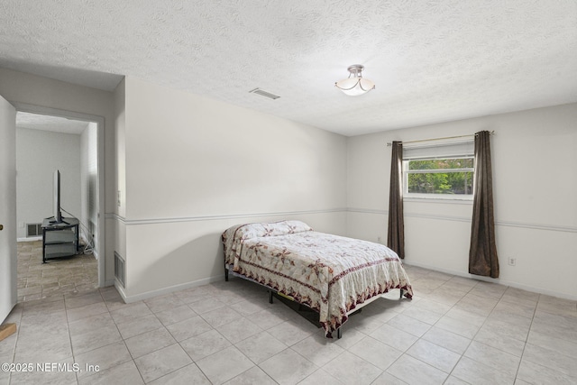 136 Hollywood Forest Dr, Fleming Island, FL 32003 - bedroom with light tile patterned floors and a textured ceiling