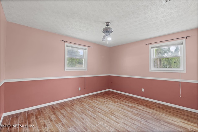 136 Hollywood Forest Dr, Fleming Island, FL 32003 - unfurnished room with plenty of natural light, wood finished floors, and a textured ceiling