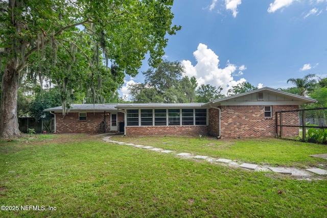 136 Hollywood Forest Dr, Fleming Island, FL 32003 - back of property featuring brick siding and a sunroom
