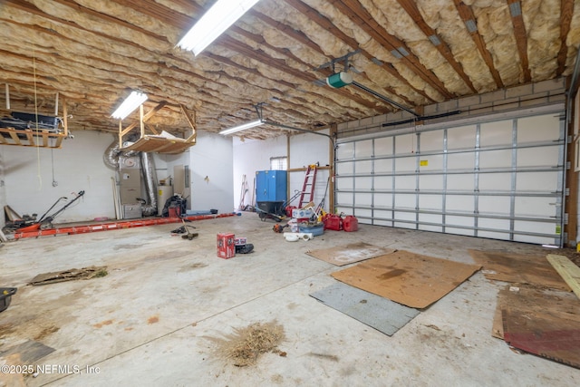 136 Hollywood Forest Dr, Fleming Island, FL 32003 - garage with gas water heater, a garage door opener, and heating unit