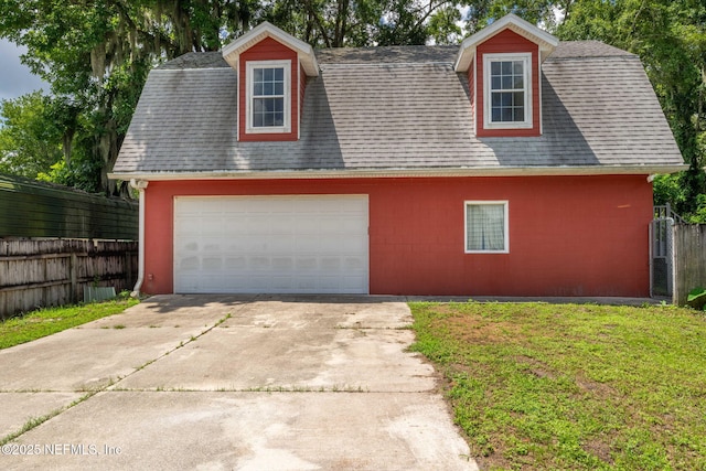 136 Hollywood Forest Dr, Fleming Island, FL 32003 - view of front of house featuring a shingled roof and a detached garage