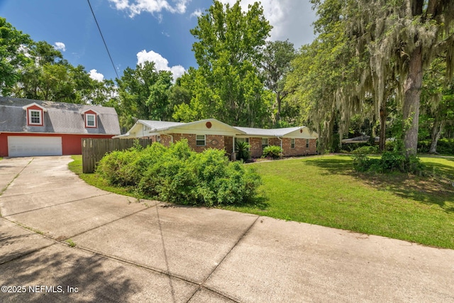 136 Hollywood Forest Dr, Fleming Island, FL 32003 - view of front of home with a garage, brick siding, and driveway