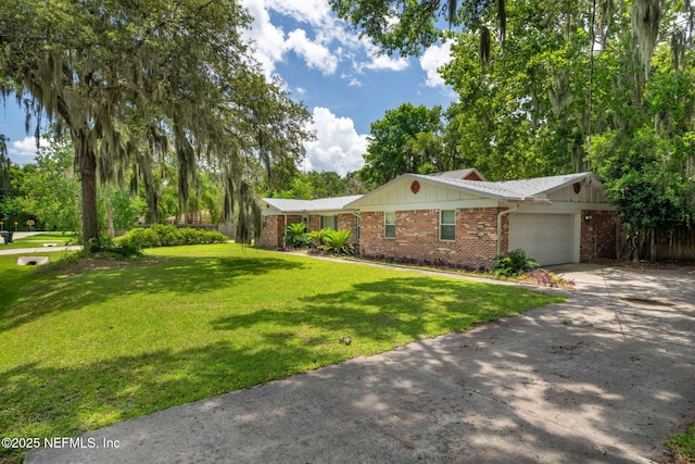 136 Hollywood Forest Dr, Fleming Island, FL 32003 - view of front of house with concrete driveway, an attached garage, a front yard, and brick siding