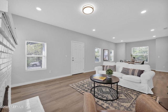 405 W 19th St, Jacksonville, FL 32206 - living room with light wood-style floors, recessed lighting, and a brick fireplace