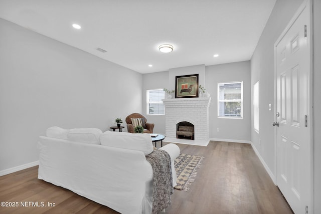 405 W 19th St, Jacksonville, FL 32206 - living room with wood finished floors, a brick fireplace, and recessed lighting