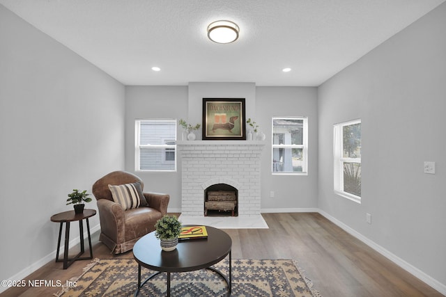 405 W 19th St, Jacksonville, FL 32206 - living area with a brick fireplace, wood finished floors, recessed lighting, and a textured ceiling
