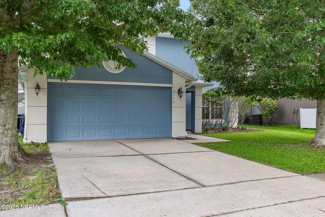 15316 Perdido Dr, Orlando, FL 32828 - view of front of property featuring concrete driveway, stucco siding, and an attached garage