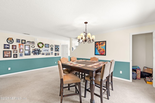 15316 Perdido Dr, Orlando, FL 32828 - dining area with light colored carpet, a chandelier, ornamental molding, and a textured ceiling