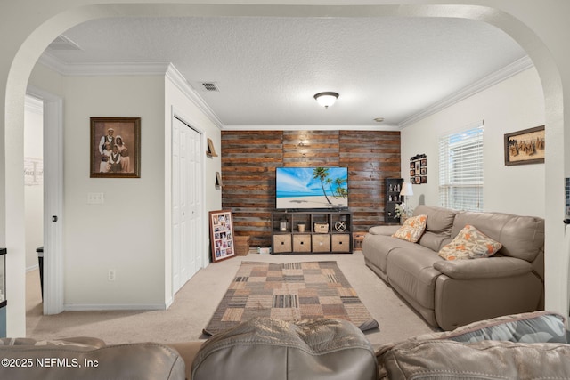 15316 Perdido Dr, Orlando, FL 32828 - living area with arched walkways, carpet, crown molding, wood walls, and a textured ceiling