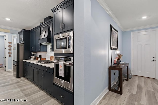 188 Sundown Covey Trl, Saint Augustine, FL 32095 - kitchen with stainless steel appliances, wall chimney range hood, light countertops, crown molding, and light wood finished floors