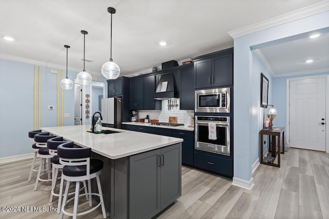 188 Sundown Covey Trl, Saint Augustine, FL 32095 - kitchen featuring appliances with stainless steel finishes, crown molding, custom range hood, a breakfast bar area, and a kitchen island with sink