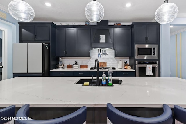 188 Sundown Covey Trl, Saint Augustine, FL 32095 - kitchen featuring stainless steel appliances, crown molding, pendant lighting, a breakfast bar area, and light stone countertops