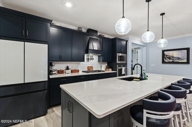 188 Sundown Covey Trl, Saint Augustine, FL 32095 - kitchen with appliances with stainless steel finishes, custom exhaust hood, crown molding, dark cabinets, and a kitchen island with sink
