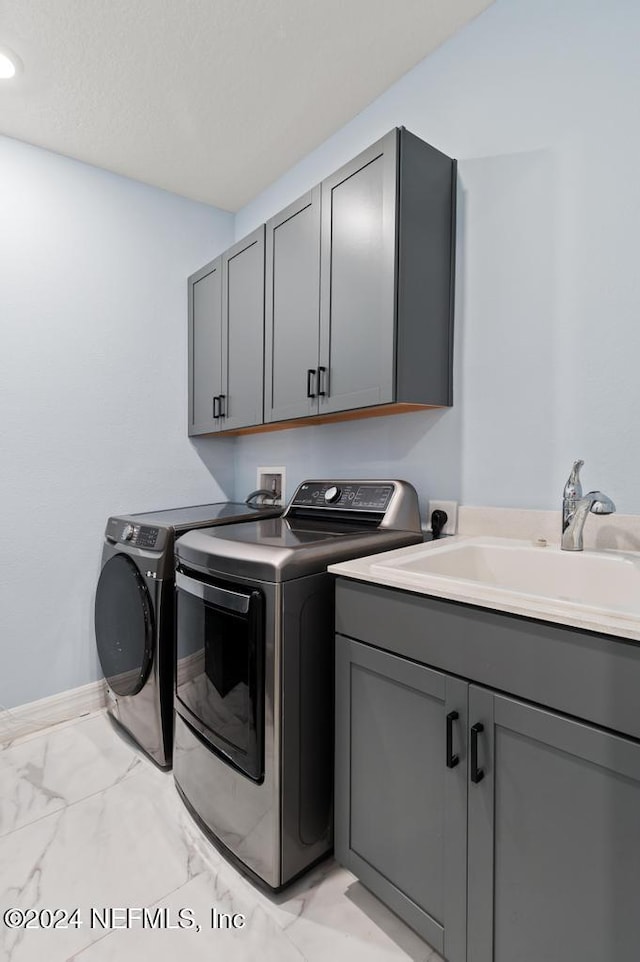 188 Sundown Covey Trl, Saint Augustine, FL 32095 - laundry area with separate washer and dryer, cabinet space, and light marble finish floors