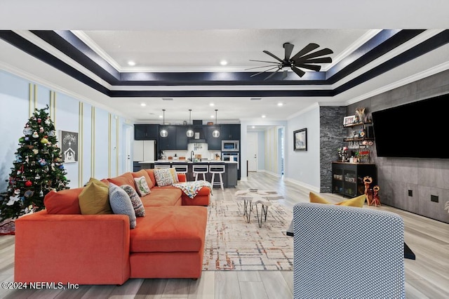 188 Sundown Covey Trl, Saint Augustine, FL 32095 - living area with crown molding, a tray ceiling, light wood-type flooring, a ceiling fan, and recessed lighting