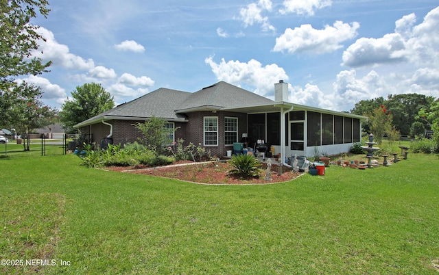 54002 Evergreen Trl, Callahan, FL 32011 - rear view of house featuring a sunroom, a chimney, a gate, brick siding, and a shingled roof