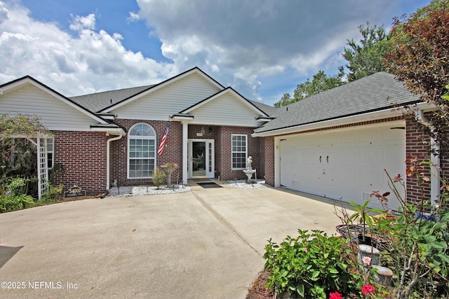 54002 Evergreen Trl, Callahan, FL 32011 - view of front facade with brick siding, concrete driveway, an attached garage, and roof with shingles