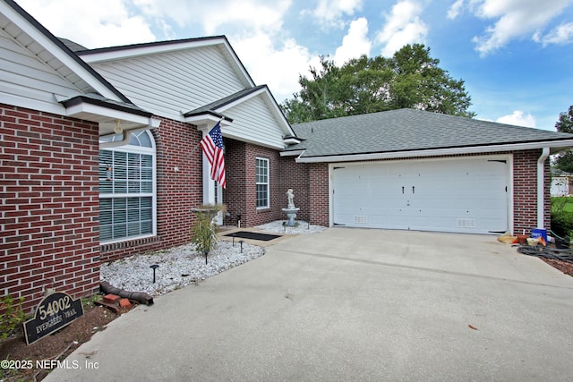 54002 Evergreen Trl, Callahan, FL 32011 - view of side of property featuring brick siding, concrete driveway, a garage, and roof with shingles