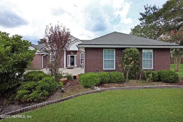 54002 Evergreen Trl, Callahan, FL 32011 - view of front of home featuring brick siding, a patio, a front yard, and roof with shingles